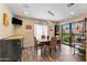Cozy dining area with modern lighting fixture, wood-look floors, and sliding door to backyard patio at 7673 N Via De Platina Dr, Scottsdale, AZ 85258