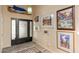 Inviting entryway featuring a stylish front door, artwork, and unique light fixture at 7673 N Via De Platina Dr, Scottsdale, AZ 85258