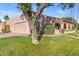 Charming home exterior with a two-car garage, covered porch, and mature trees at 7673 N Via De Platina Dr, Scottsdale, AZ 85258
