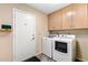 Efficient laundry room with washer, dryer, ample cabinet space and access door at 7673 N Via De Platina Dr, Scottsdale, AZ 85258