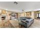 Open living room with a fireplace, large sectional sofa, and access to the backyard at 7673 N Via De Platina Dr, Scottsdale, AZ 85258
