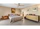 Comfortable main bedroom with neutral tones, ceiling fan, and ensuite bathroom access at 7673 N Via De Platina Dr, Scottsdale, AZ 85258