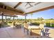 Community patio area with tables, chairs, and picturesque views of the golf course and pond at 7673 N Via De Platina Dr, Scottsdale, AZ 85258