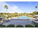 Community pool and lake view with lounge seating and manicured landscaping at 7673 N Via De Platina Dr, Scottsdale, AZ 85258