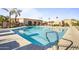 Inviting community swimming pool with clear blue water, palm trees, and comfortable lounge area at 7673 N Via De Platina Dr, Scottsdale, AZ 85258