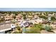 Expansive aerial view showcasing a residential neighborhood with single-Gathering homes, lush landscaping, and a community pool at 7749 W Hearn Rd, Peoria, AZ 85381