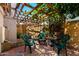 Cozy backyard patio with brick flooring, lattice covering, and ample seating at 7749 W Hearn Rd, Peoria, AZ 85381