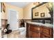 Elegant bathroom featuring a custom vanity, granite countertop, and decorative mirror and accents at 7749 W Hearn Rd, Peoria, AZ 85381