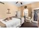 Warm bedroom featuring a bed, a comfortable sitting area, an ensuite bathroom, and natural light at 7749 W Hearn Rd, Peoria, AZ 85381