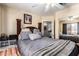 Traditional bedroom showcases a stylish bed, soft gray bedding, and direct access to the ensuite at 7749 W Hearn Rd, Peoria, AZ 85381