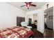 This bedroom has a ceiling fan, large upholstered chair, and a sliding closet door that reflects the room at 7749 W Hearn Rd, Peoria, AZ 85381