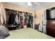 Bright and airy bedroom showcases a ceiling fan, large closet with hanging storage, and a queen bed at 7749 W Hearn Rd, Peoria, AZ 85381