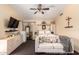 Charming bedroom with a bed, couch, ceiling fan, and built-in storage, creating a relaxing retreat at 7749 W Hearn Rd, Peoria, AZ 85381