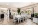 Bright dining room with a large bay window and white chairs, perfect for Gathering gatherings and entertaining guests at 7749 W Hearn Rd, Peoria, AZ 85381