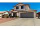 Charming two-story home with a well-manicured front yard, and a two car garage at 7749 W Hearn Rd, Peoria, AZ 85381