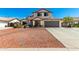 Charming two-story home with a well-manicured front yard, and a two car garage at 7749 W Hearn Rd, Peoria, AZ 85381