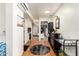 Hallway with wood floors, a bar cart, and views into the laundry and kitchen at 7749 W Hearn Rd, Peoria, AZ 85381