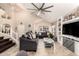 Spacious living room with vaulted ceilings, tile floors, and custom built in entertainment center at 7749 W Hearn Rd, Peoria, AZ 85381