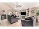 Spacious living room with vaulted ceilings, tile floors, and custom built in entertainment center at 7749 W Hearn Rd, Peoria, AZ 85381
