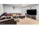 Comfortable living room with a large gray sectional sofa, a TV, and neutral decor at 7749 W Hearn Rd, Peoria, AZ 85381