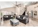 Spacious living room with vaulted ceilings, tile floors, and two large couches at 7749 W Hearn Rd, Peoria, AZ 85381