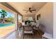 A covered outdoor dining table with seating next to the pool at 7749 W Hearn Rd, Peoria, AZ 85381