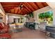 Outdoor living with a full kitchen, seating, and view of a verdant backyard at 7749 W Hearn Rd, Peoria, AZ 85381