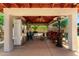 An outdoor living area with stainless steel fridge, ceiling fan, TV and ample seating at 7749 W Hearn Rd, Peoria, AZ 85381