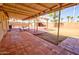 Spacious, covered back patio featuring brick pavers and a picnic table at 809 N Gilbert Ave, Casa Grande, AZ 85122