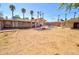 Large backyard with a sparkling pool, covered patio, and mature trees, perfect for outdoor living at 809 N Gilbert Ave, Casa Grande, AZ 85122