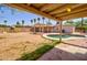 Lush backyard with a covered patio, pool, and well-maintained landscaping at 809 N Gilbert Ave, Casa Grande, AZ 85122