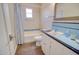 Traditional bathroom features a tiled vanity and shower/tub with blue accent tiles and wood-look floor at 809 N Gilbert Ave, Casa Grande, AZ 85122