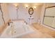 Well-lit bathroom with a soaking tub, pedestal sink, and shower stall at 809 N Gilbert Ave, Casa Grande, AZ 85122