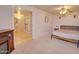 Bright and airy bedroom with soft carpet, ceiling fan, and ensuite bathroom at 809 N Gilbert Ave, Casa Grande, AZ 85122