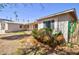 Exterior view of house with a lush bush, complemented by a well-maintained lawn at 809 N Gilbert Ave, Casa Grande, AZ 85122