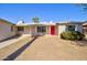 Charming single-story home with a vibrant red front door and well-maintained yard at 809 N Gilbert Ave, Casa Grande, AZ 85122