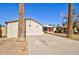 Front exterior with desert landscaping and a concrete driveway leading to the home at 809 N Gilbert Ave, Casa Grande, AZ 85122