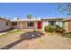 Charming single-story home featuring a cozy porch and vibrant red front door at 809 N Gilbert Ave, Casa Grande, AZ 85122