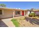 Charming single-story home with a red front door and well-maintained front yard at 809 N Gilbert Ave, Casa Grande, AZ 85122