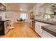 Traditional-style kitchen with hardwood floors and stainless steel appliances adjacent to dining area at 809 N Gilbert Ave, Casa Grande, AZ 85122