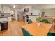 Open concept kitchen with stainless steel appliances and hardwood floors connected to the living area at 809 N Gilbert Ave, Casa Grande, AZ 85122