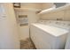 Laundry area with washer and dryer and practical shelving for storage, providing utility and organization at 809 N Gilbert Ave, Casa Grande, AZ 85122