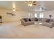 Bright living room featuring a large sectional sofa and multiple ceiling fans for added comfort at 809 N Gilbert Ave, Casa Grande, AZ 85122