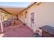 Covered patio offering a shaded outdoor dining area and access to a lush backyard at 809 N Gilbert Ave, Casa Grande, AZ 85122