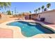 Backyard oasis with a refreshing pool, lush landscaping, and shaded seating area at 809 N Gilbert Ave, Casa Grande, AZ 85122