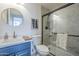 Modern bathroom with marble shower and blue vanity at 8370 W Audrey Ln, Peoria, AZ 85382