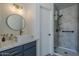 Bathroom vanity with white countertops, gray cabinets, and a shower at 8370 W Audrey Ln, Peoria, AZ 85382