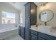 Bathroom featuring double vanity sinks, modern fixtures, and a luxurious tub at 8370 W Audrey Ln, Peoria, AZ 85382