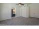 Bright bedroom featuring a ceiling fan and closet space with an arched entrance to the bathroom at 8370 W Audrey Ln, Peoria, AZ 85382