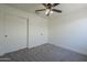 Cozy bedroom featuring carpet, ceiling fan, and closet at 8370 W Audrey Ln, Peoria, AZ 85382